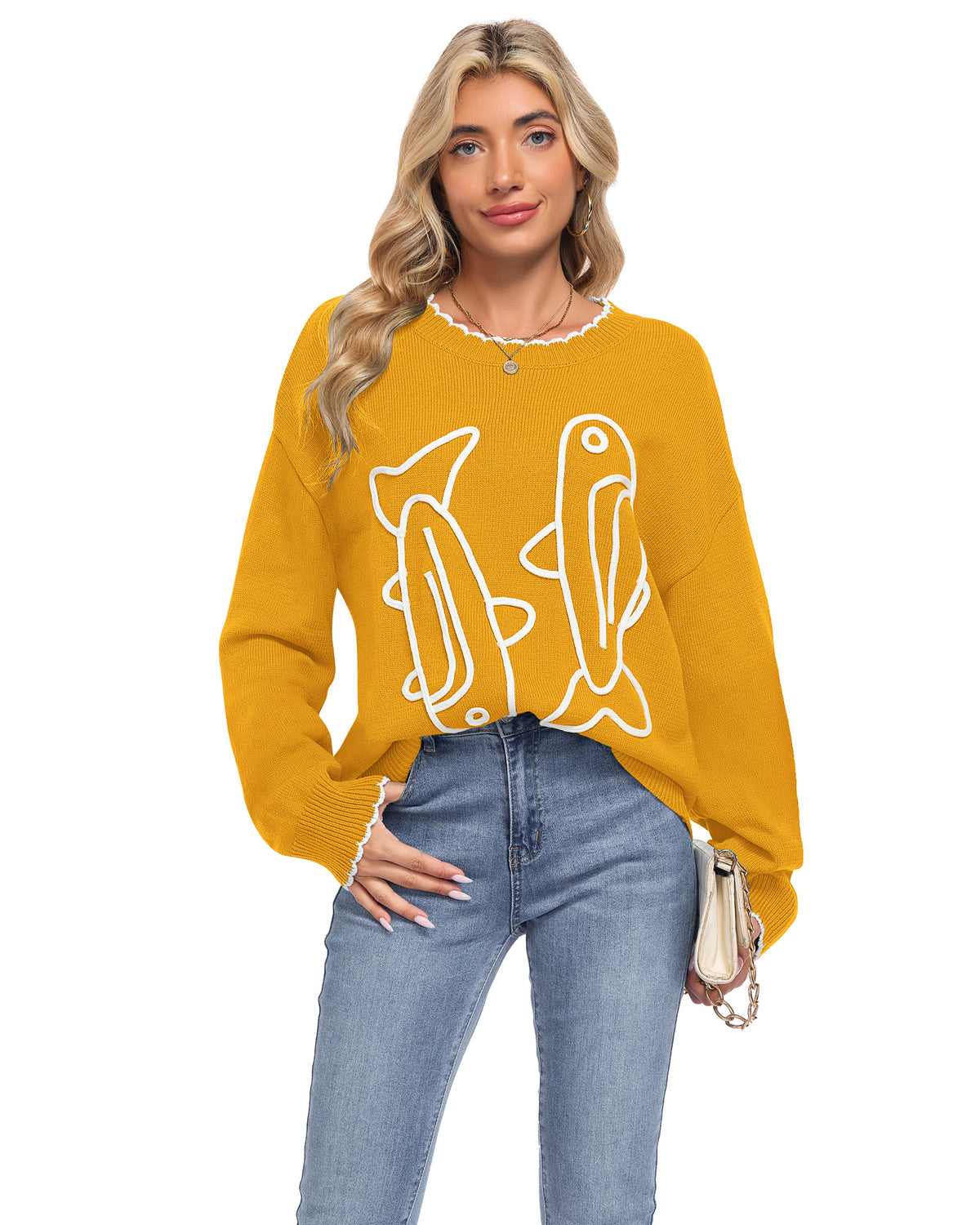 Model wearing an AUSELILY mustard yellow sardine sweater with white cord embroidered fish and scalloped neckline and cuffs