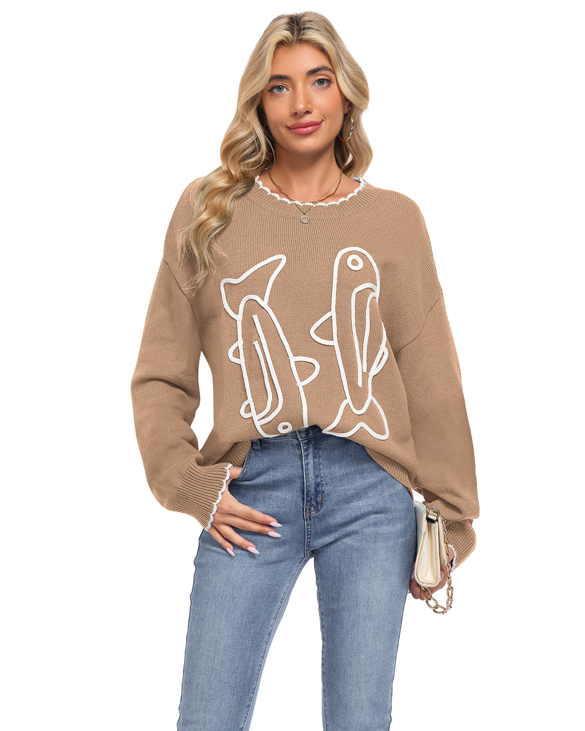 Model wearing an AUSELILY khaki sardine sweater with white cord embroidered fish and scalloped neckline and cuffs